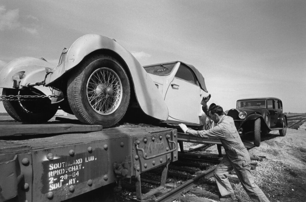 A 1957 Bugatti loaded onto a train flatcar