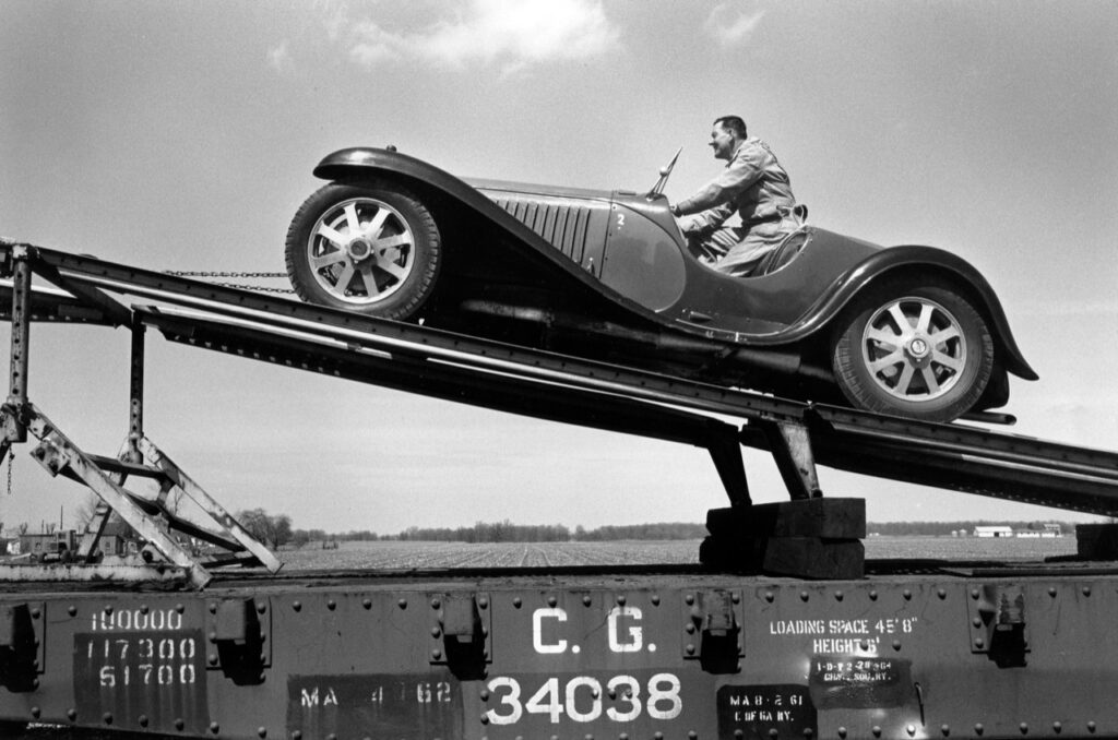 A 1932 Type 55 is loaded onto the railcar. 