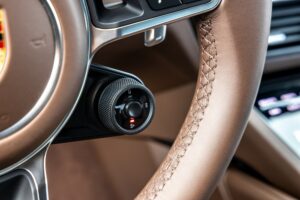 performance modes are engaged via a small dial at the lower right spoke of the steering wheel.