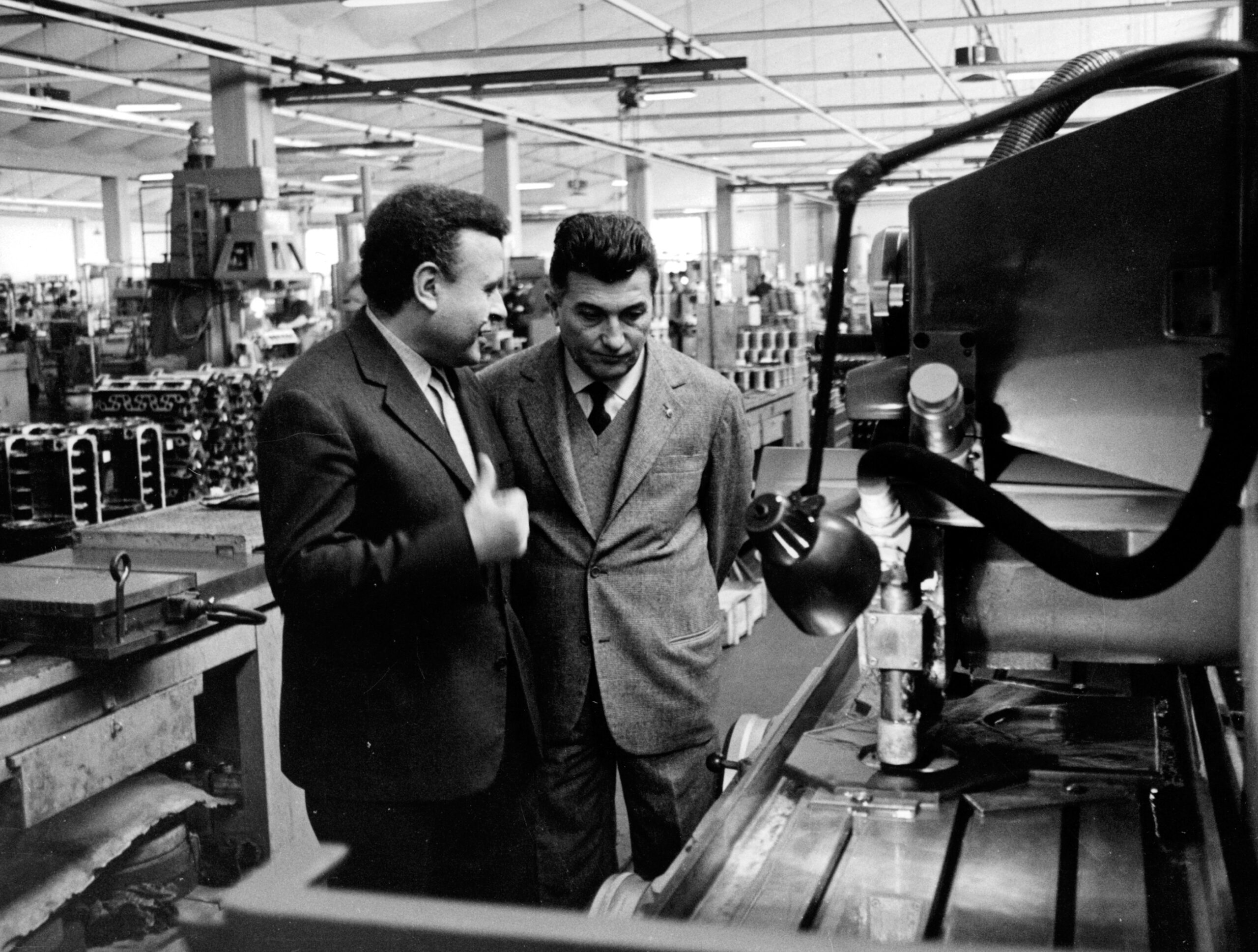 Ferruccio Lamborghini confers on the factory floor with another executive.