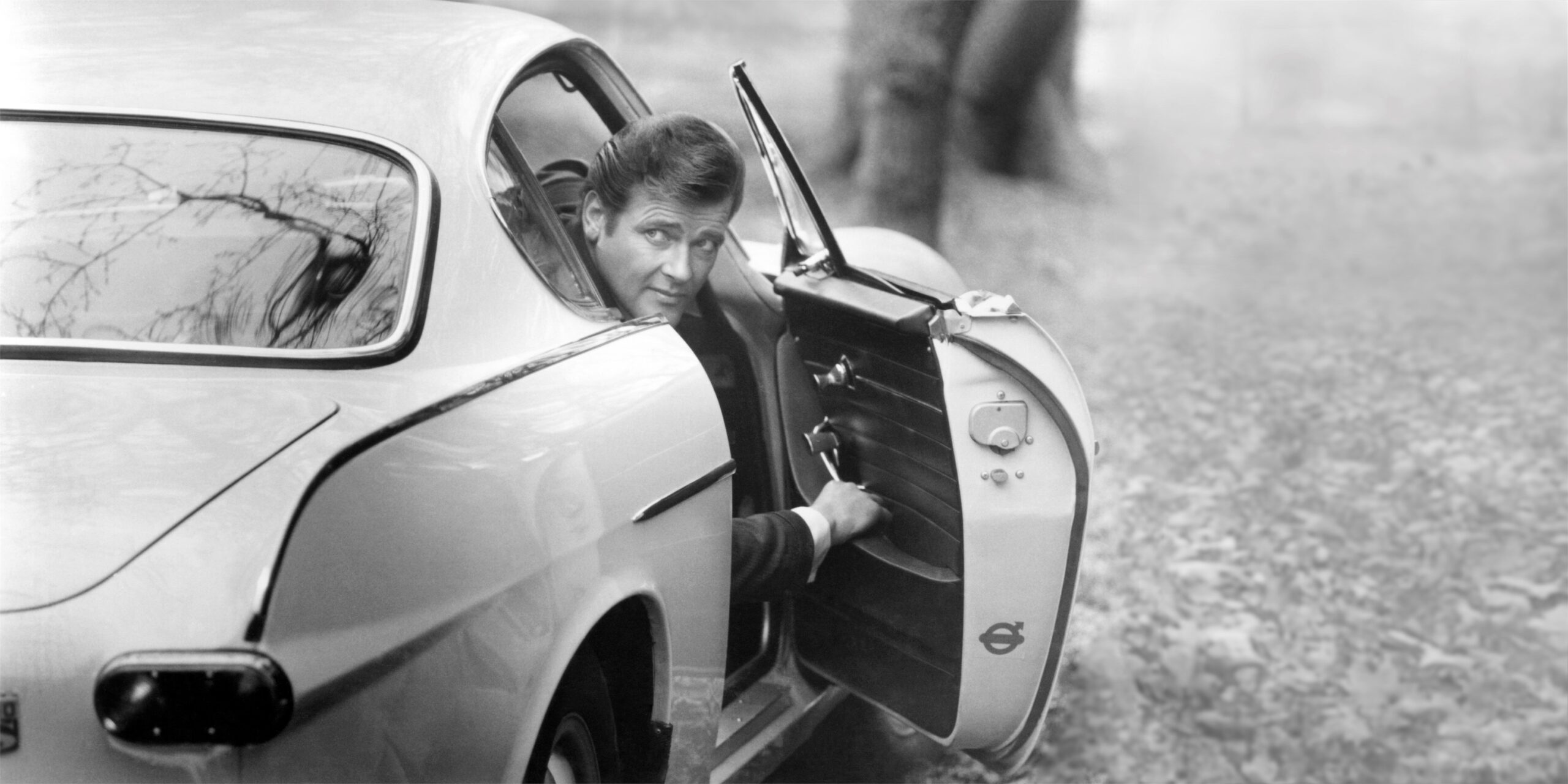 A studio photo of Roger Moore with the P1800 used in the TV series.