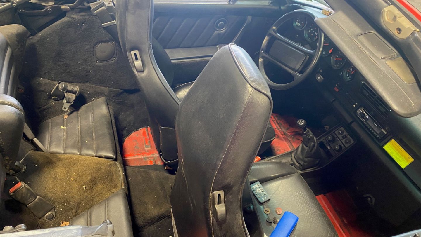 a1986 Porsche 911 Cabriolet with a distressed interior. 