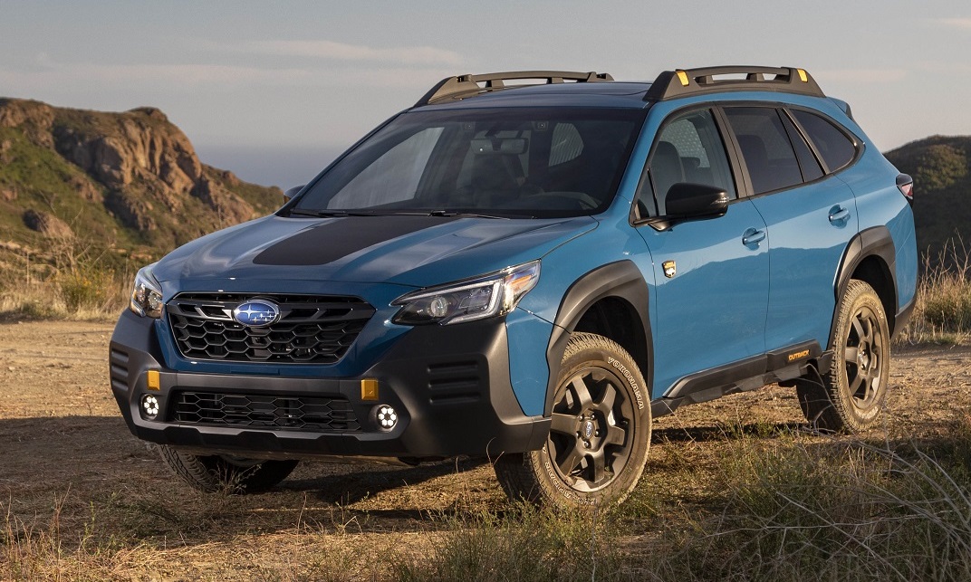 A blue 2022 Subaru Outback Wilderness model on a dirt trail