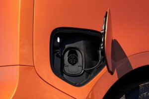 Showing the open charge door on the right rear. The ID Buzz charging port has a CCS plug connector for use at DC fast-charging stations.