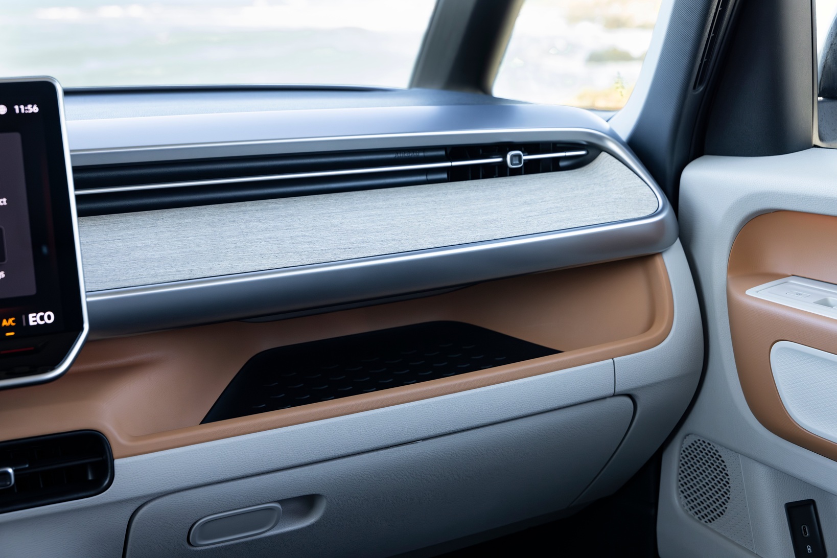 Small storage areas are notched throughout the interior, like this one on the passenger side of the dashboard