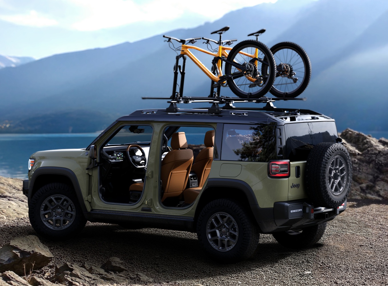 The electric 2026 Jeep Recon shown with side doors removed and a pair of mountain bikes mounted on a roof top carrier.,