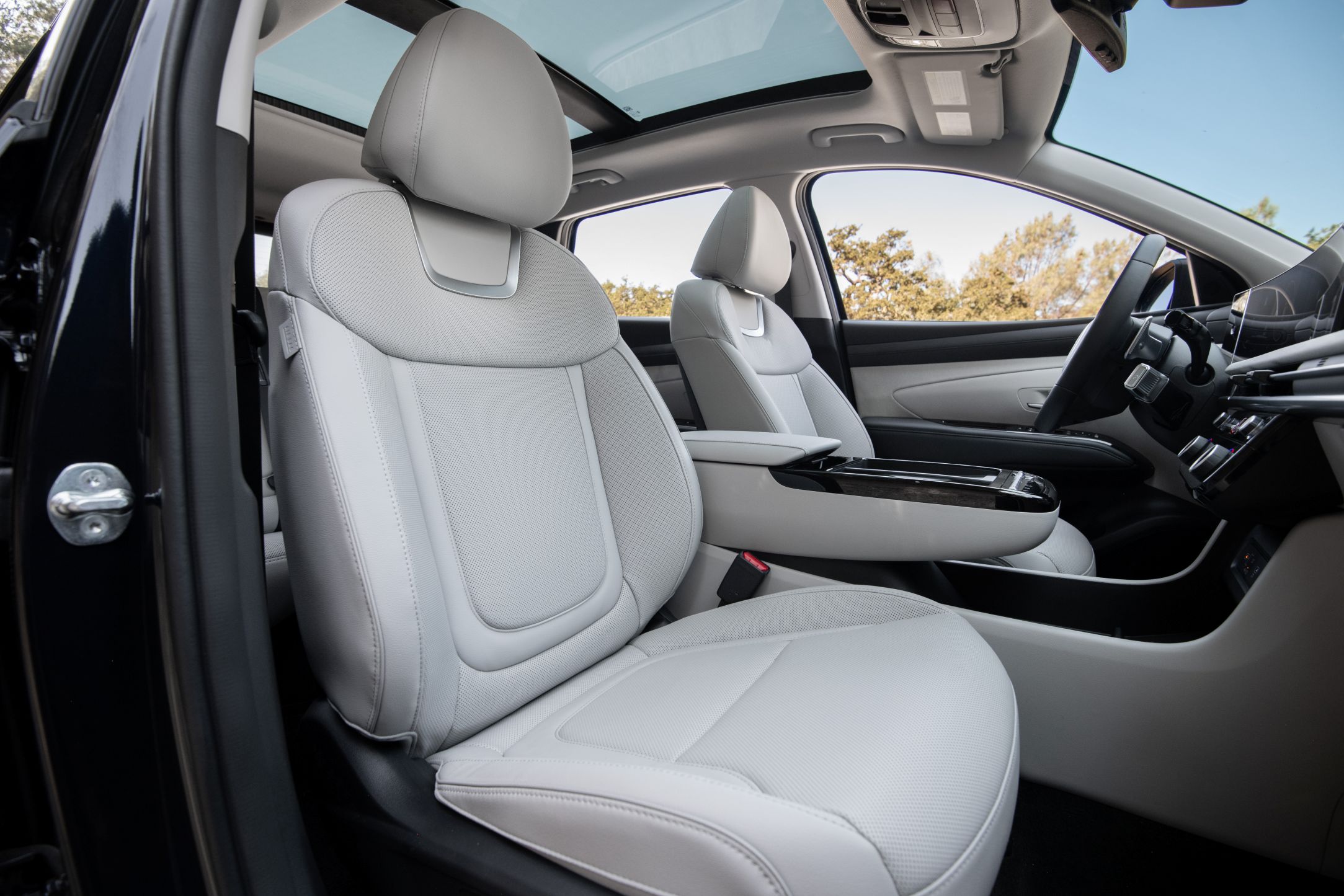 Looking into the passenger door of the Tucson hybrid at the neatly leather-trimmed seat