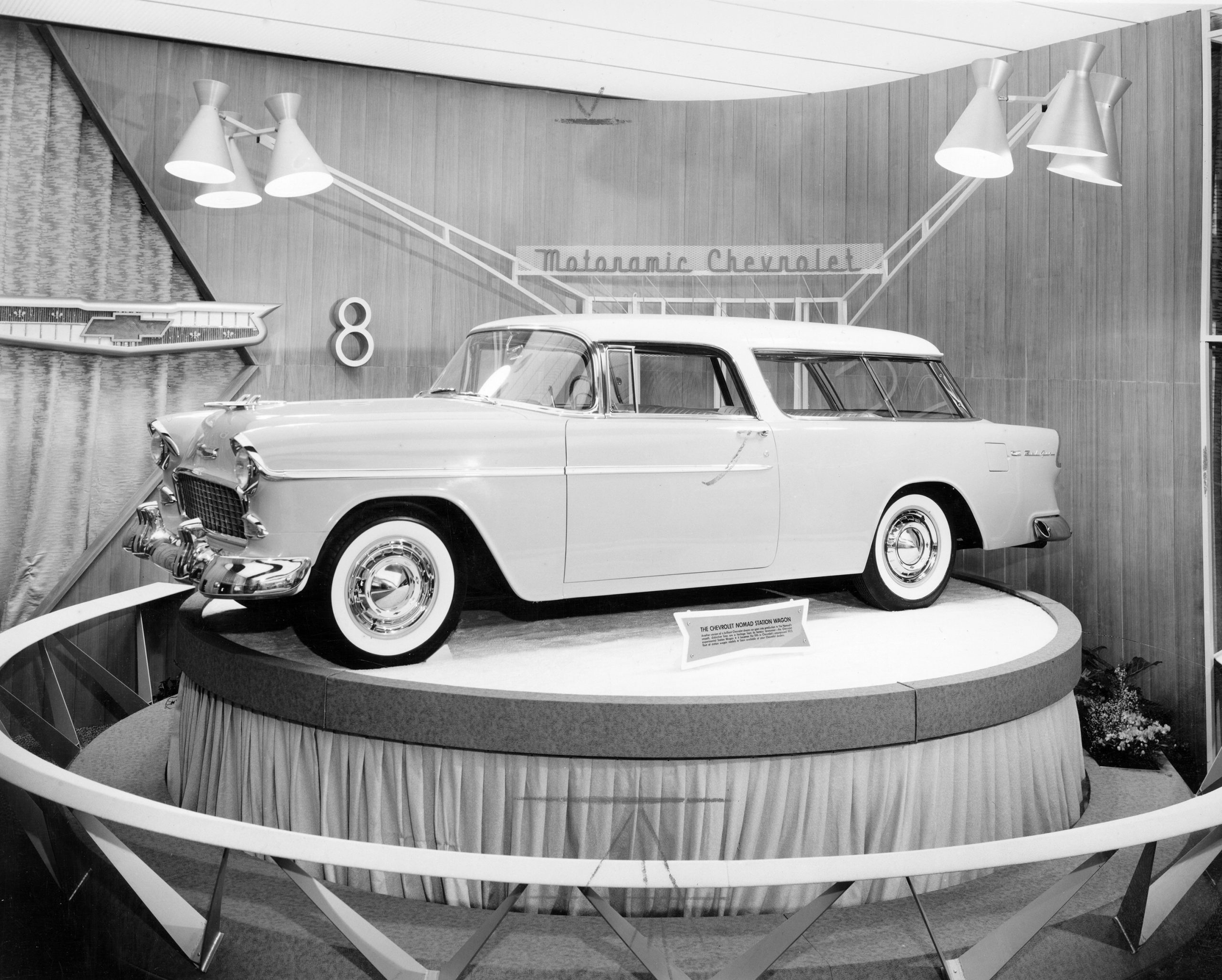 A black and white image of the 1955 Chevrolet Bel Air Nomad in a Chevrolet Motoramic display. The special plaque: “Another version of a brilliant Chevrolet dream car goes into production.”