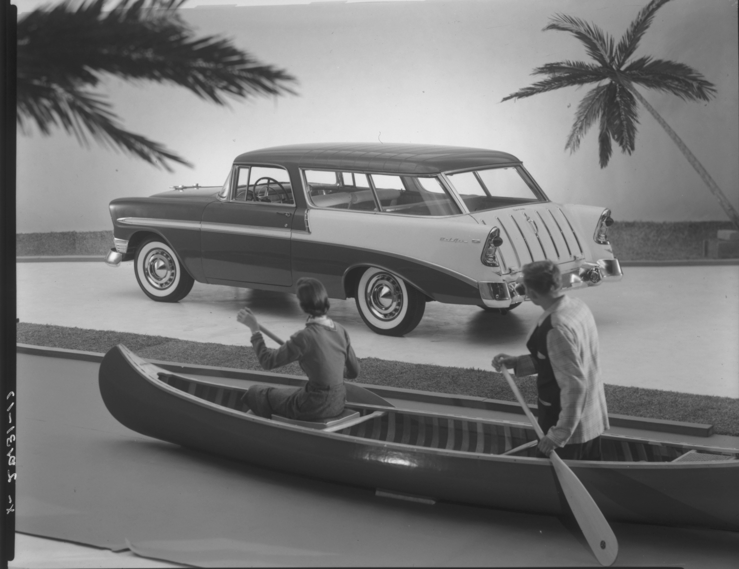 1956 Chevrolet Nomad advertising image amid South Pacific scenery yet with couple in canoe.