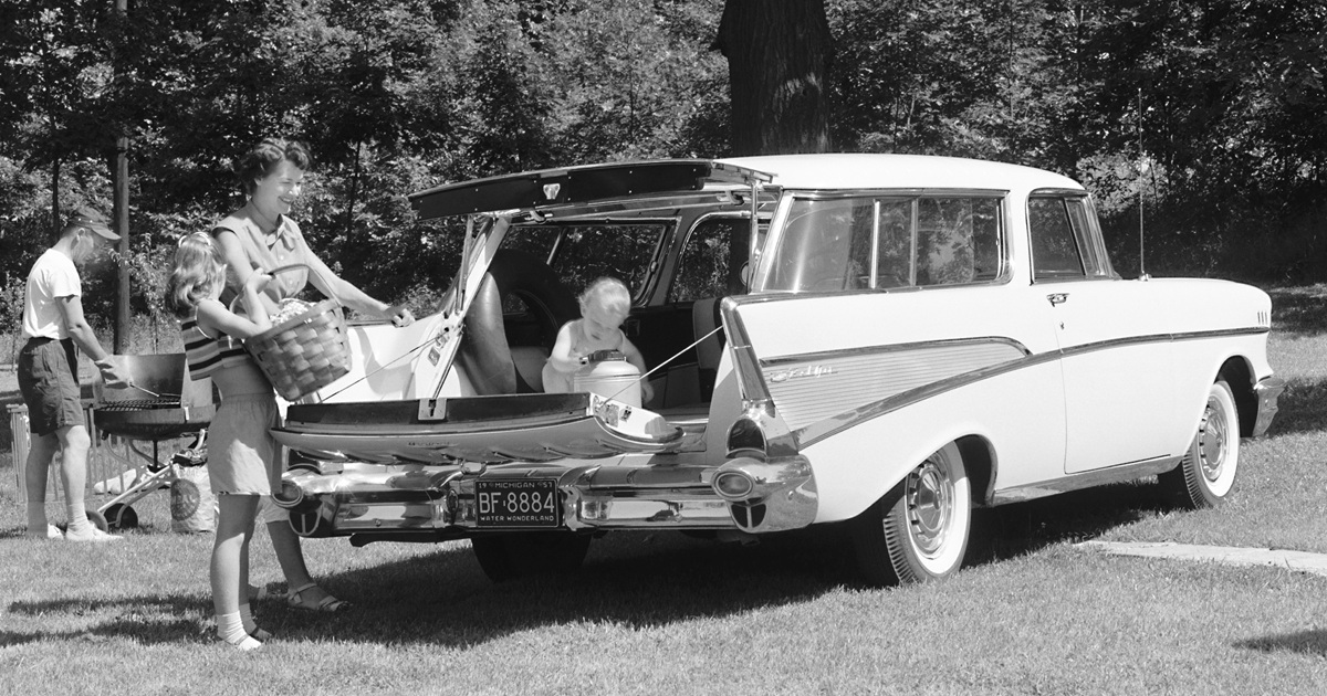 A 1957 Chevrolet Bel Air Nomad. Black and white With family at the lake.