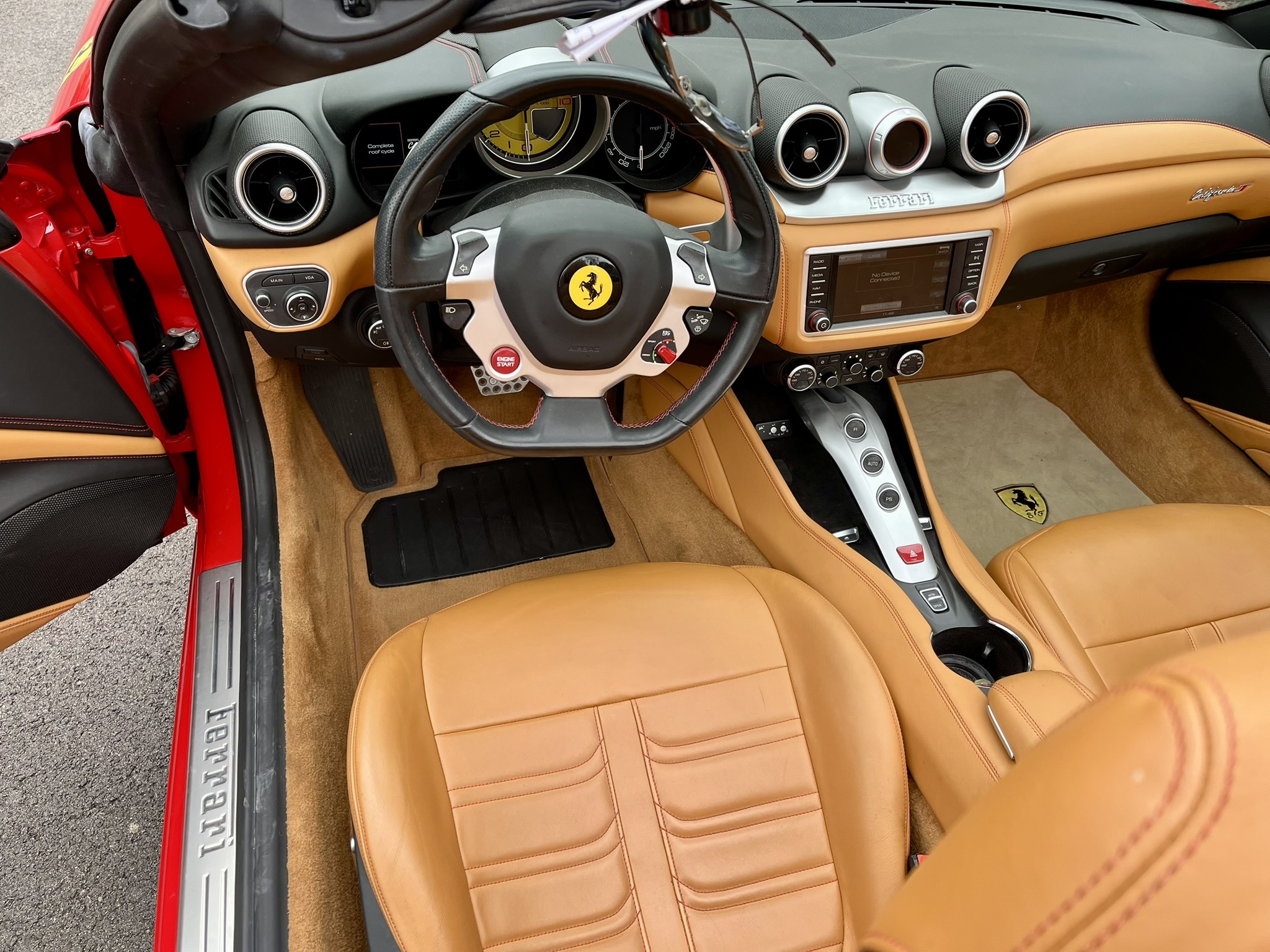 The Ferrari's leather upholstery shows no wear or sagging.