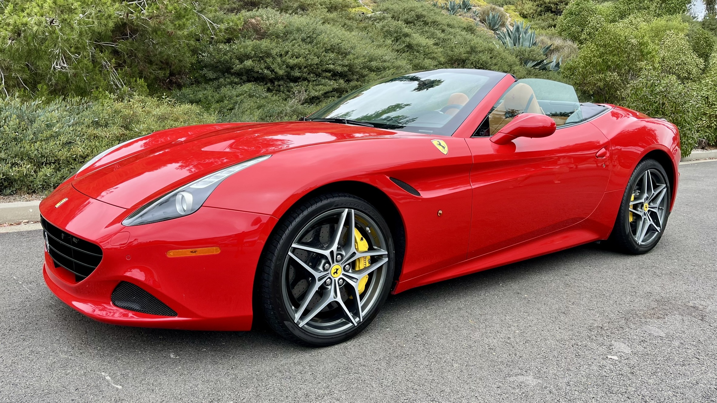 A front three quarter view of the Ferrari California T in Rosso re