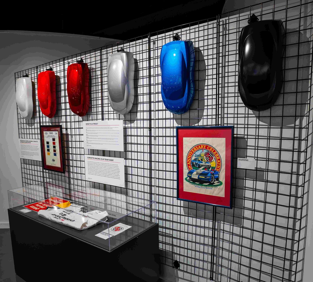 color paint ‘frogs’ in the shape of a sports car hang on a wire rack display panel. The frogs help color designers’ decisions long before a car ever rolls off the assembly line.