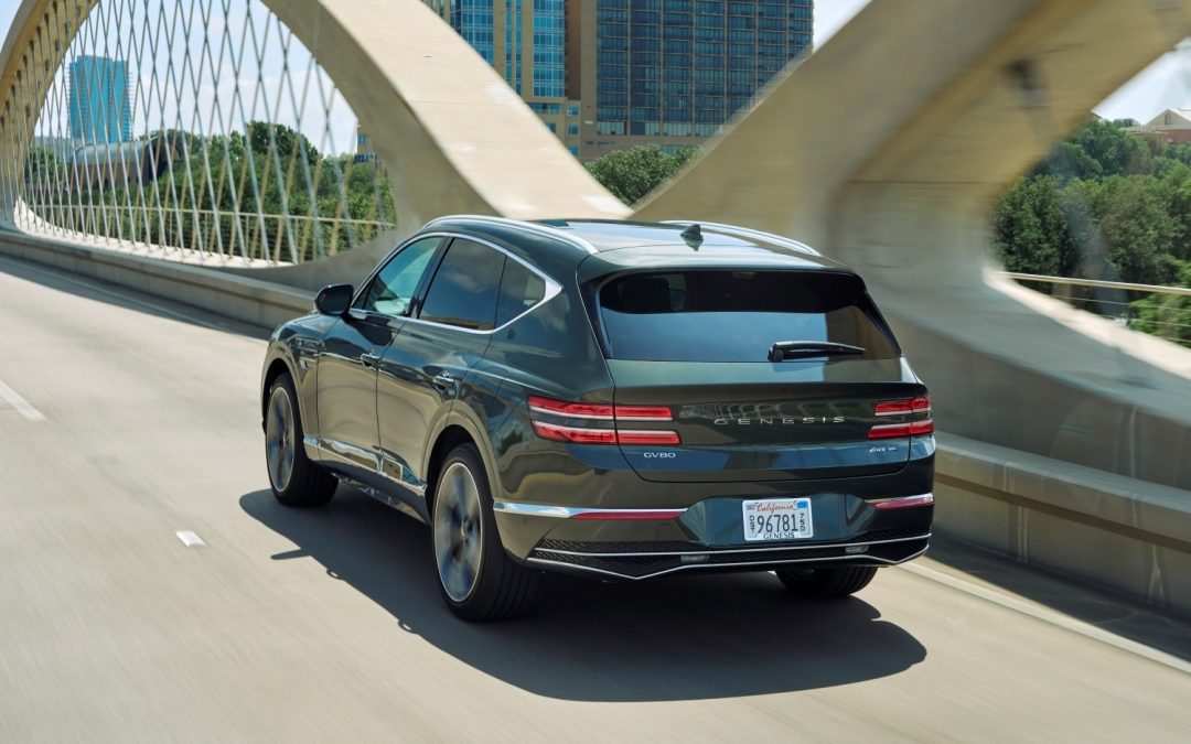 Looking at the rear end of a GV80 driving across a bridge span