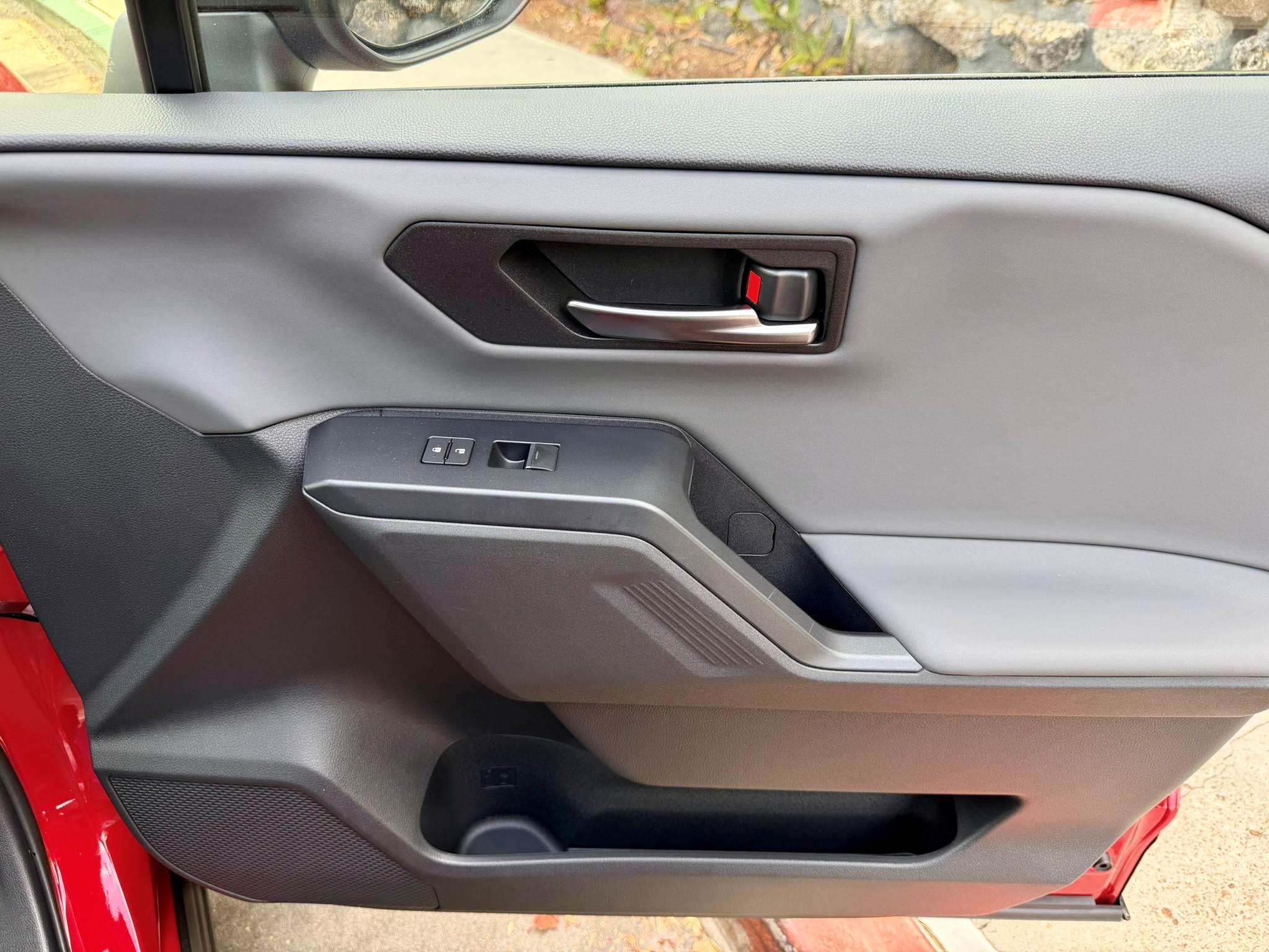 Looking at the front passenger side door panel with a strong grab handle and storage
